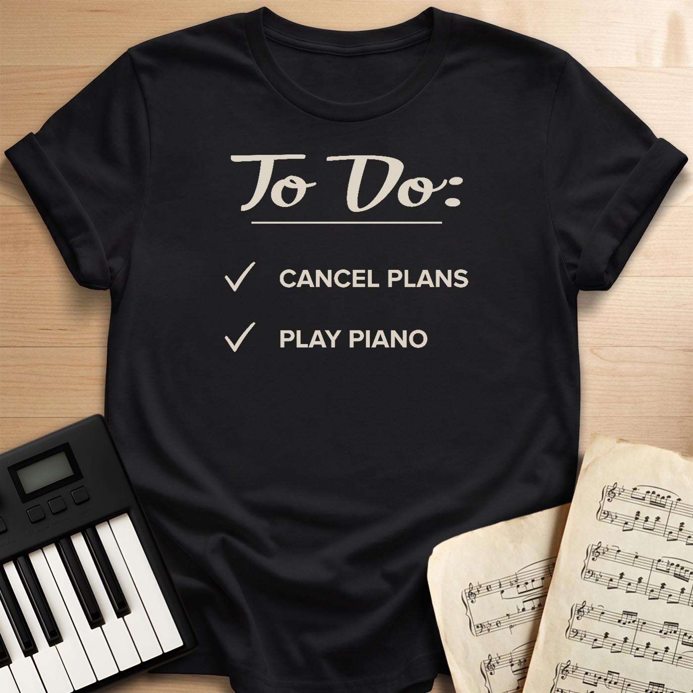 Black To Do Cancel Plans Play Piano t-shirt, flat lay with piano keyboard and sheet music