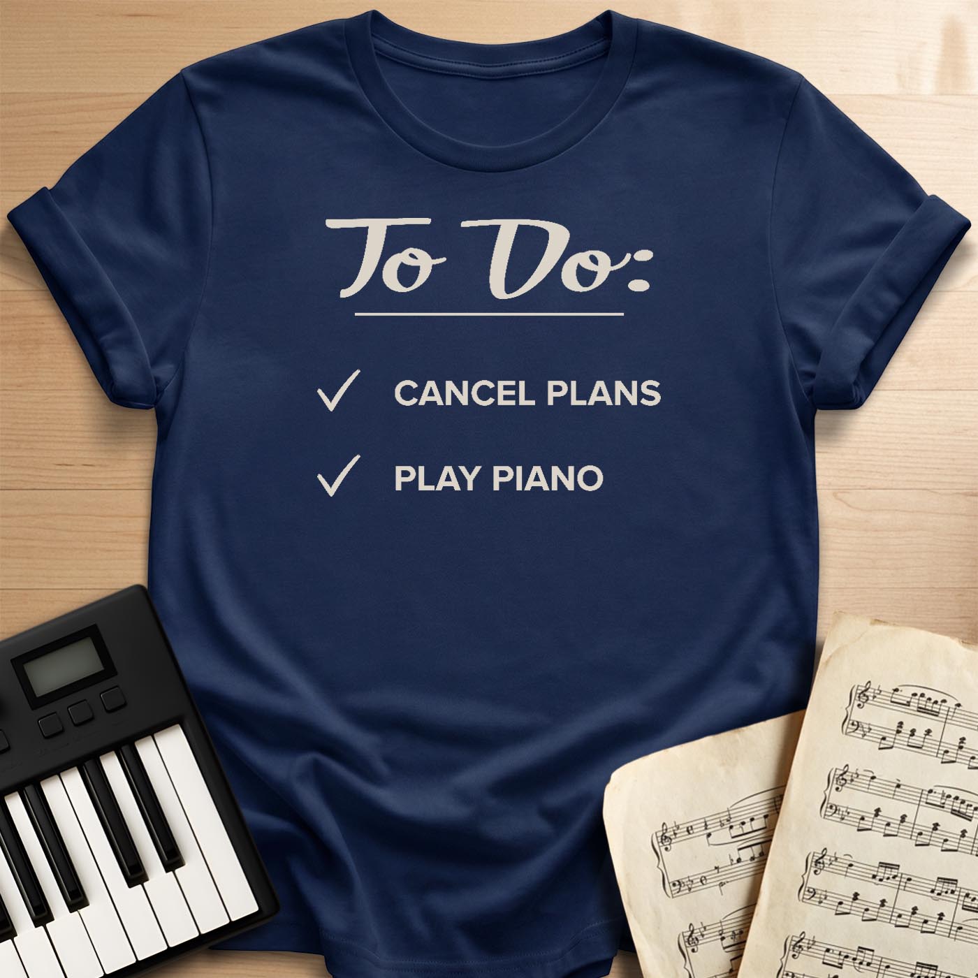 Navy To Do Cancel Plans Play Piano t-shirt, flat lay with piano keyboard and sheet music