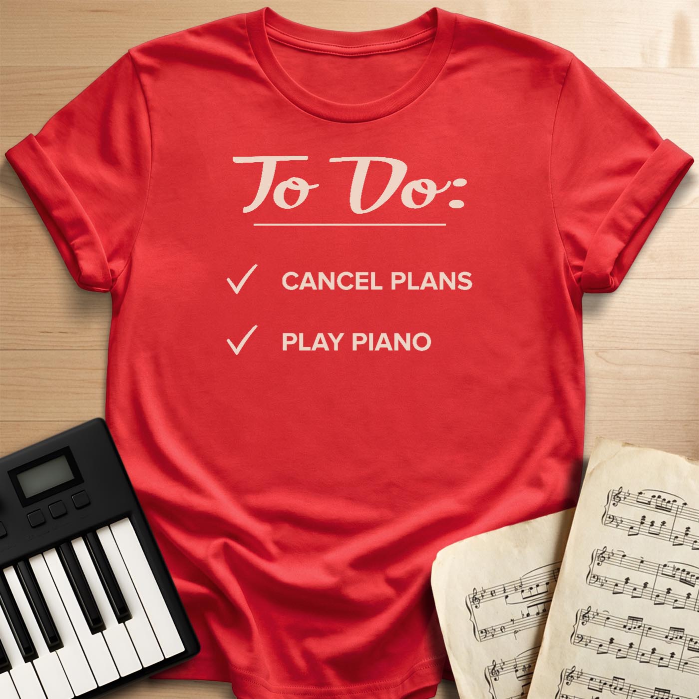 Red To Do Cancel Plans Play Piano t-shirt, flat lay with piano keyboard and sheet music