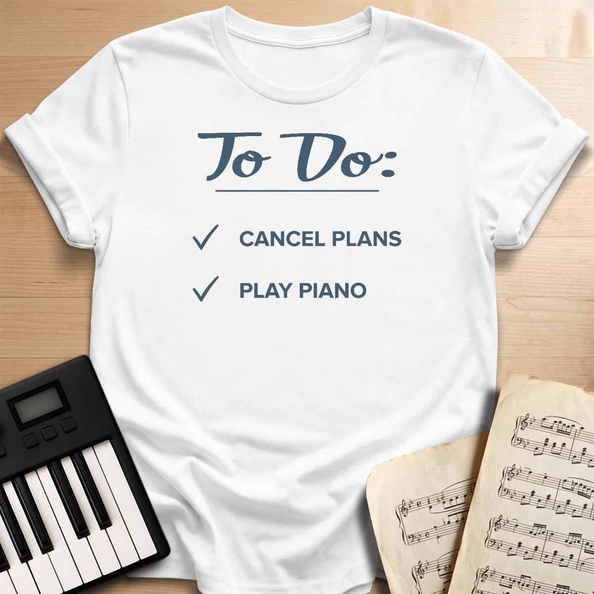 White To Do Cancel Plans Play Piano t-shirt, flat lay with piano keyboard and sheet music